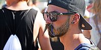 young man with mustache glasses